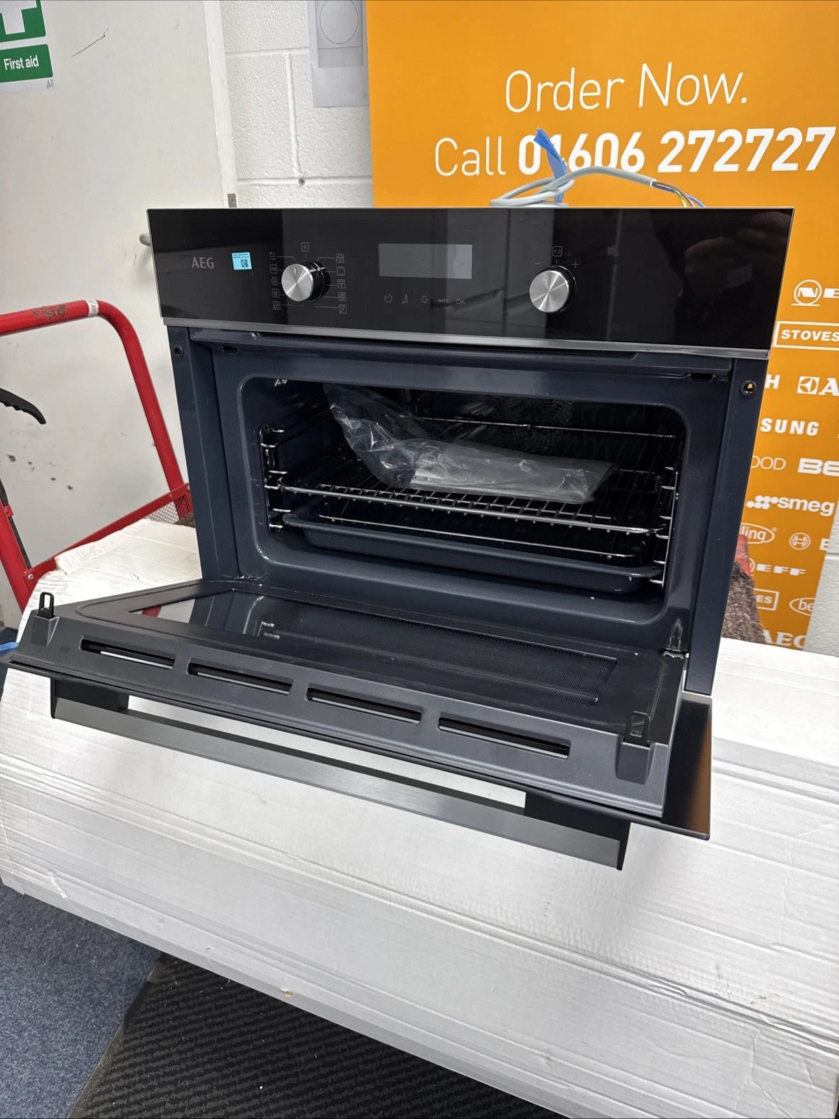 AEG 6000 Series GK6NK401B Combi Quick Compact Built-in Combination Microwave Oven in Black from HomeWise Appliances. Shop photo front with door open.