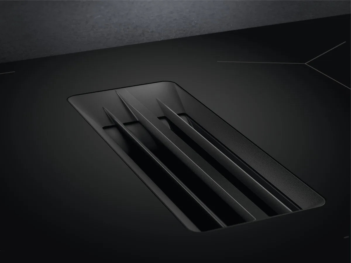AEG Series 7000 NCH84C23AB 80cm Induction Hob with Venting Extraction and SenseFry® in Matt Black - A+ Rated. Stock photo close up of the cast iron cover for venting extraction.