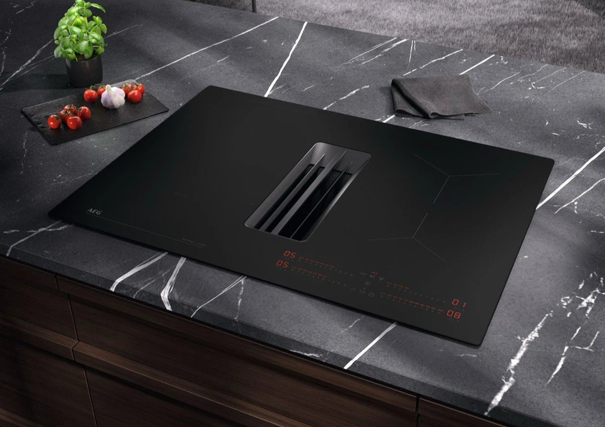 AEG TCH74B01CB 68cm 4 Zone Induction Hob with Integrated Venting Hood in Black from HomeWise Appliances. Stock photo of hob inserted in the worktop